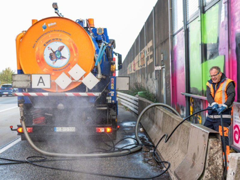 Mitarbeiter der Kanalreinigung Dihn säubert einen verstopften Kanal an einer Autobahn